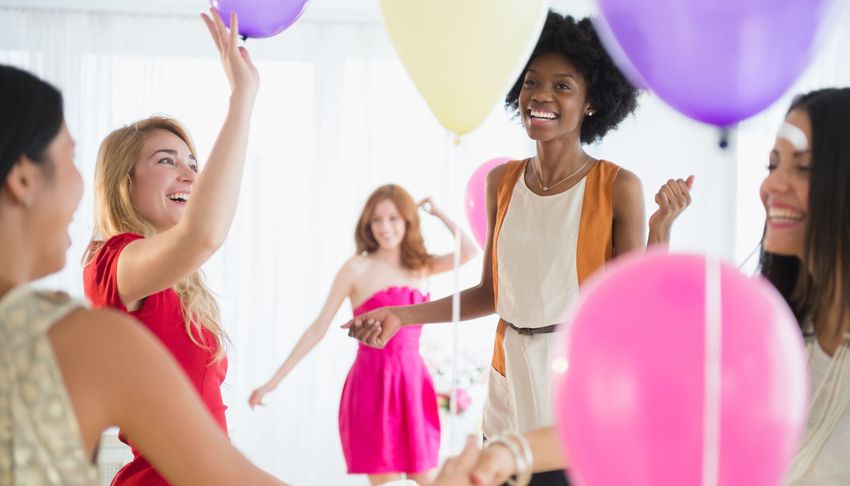 Women playing with balloons at party