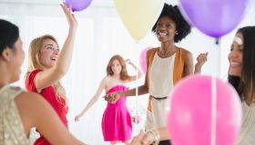 Women playing with balloons at party