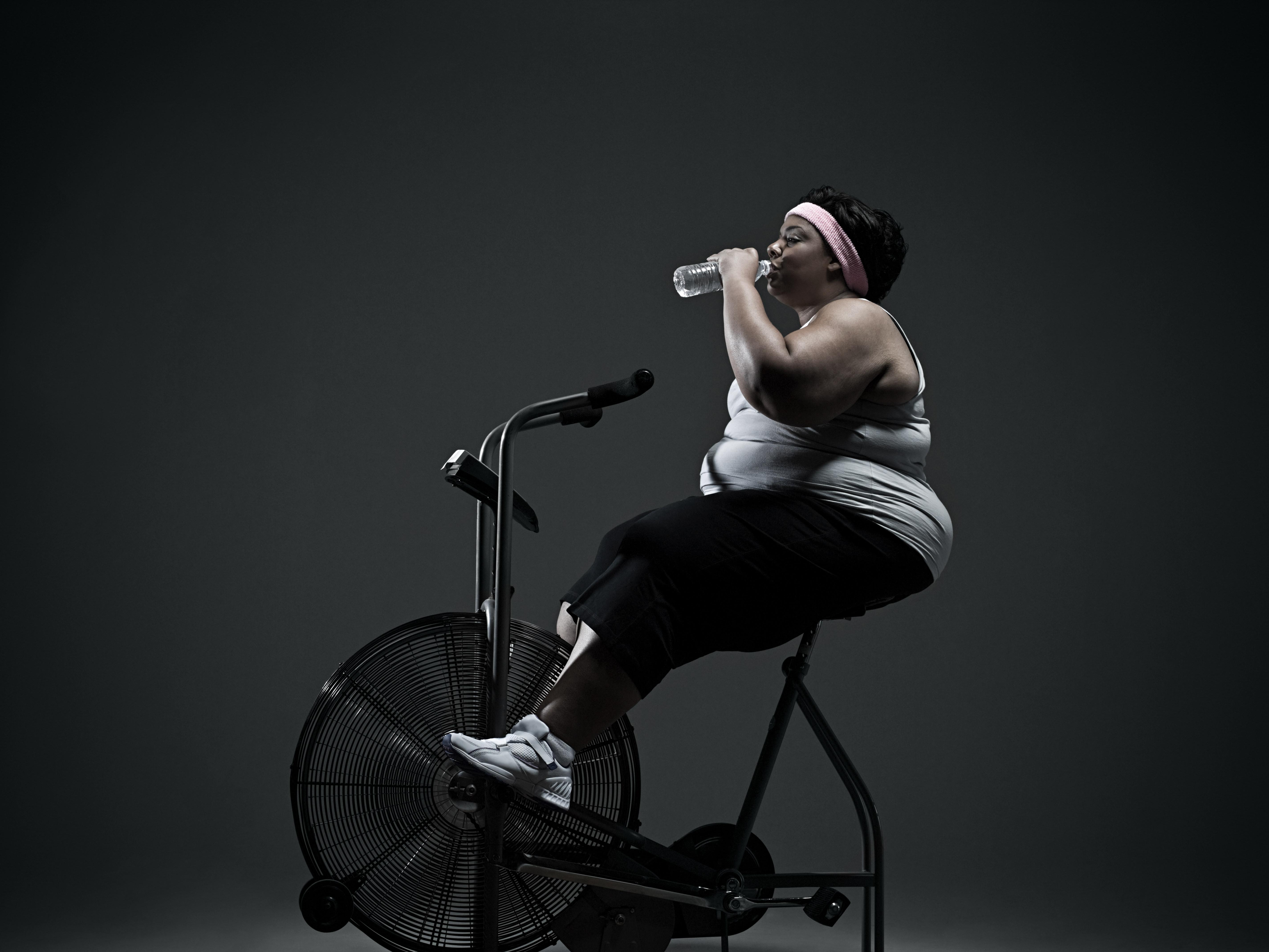 Overweight woman on exercise bike