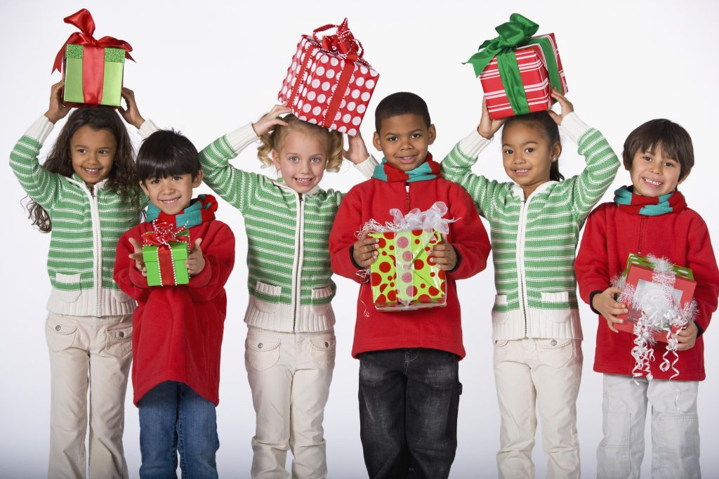 Multi-ethnic children holding Christmas gifts