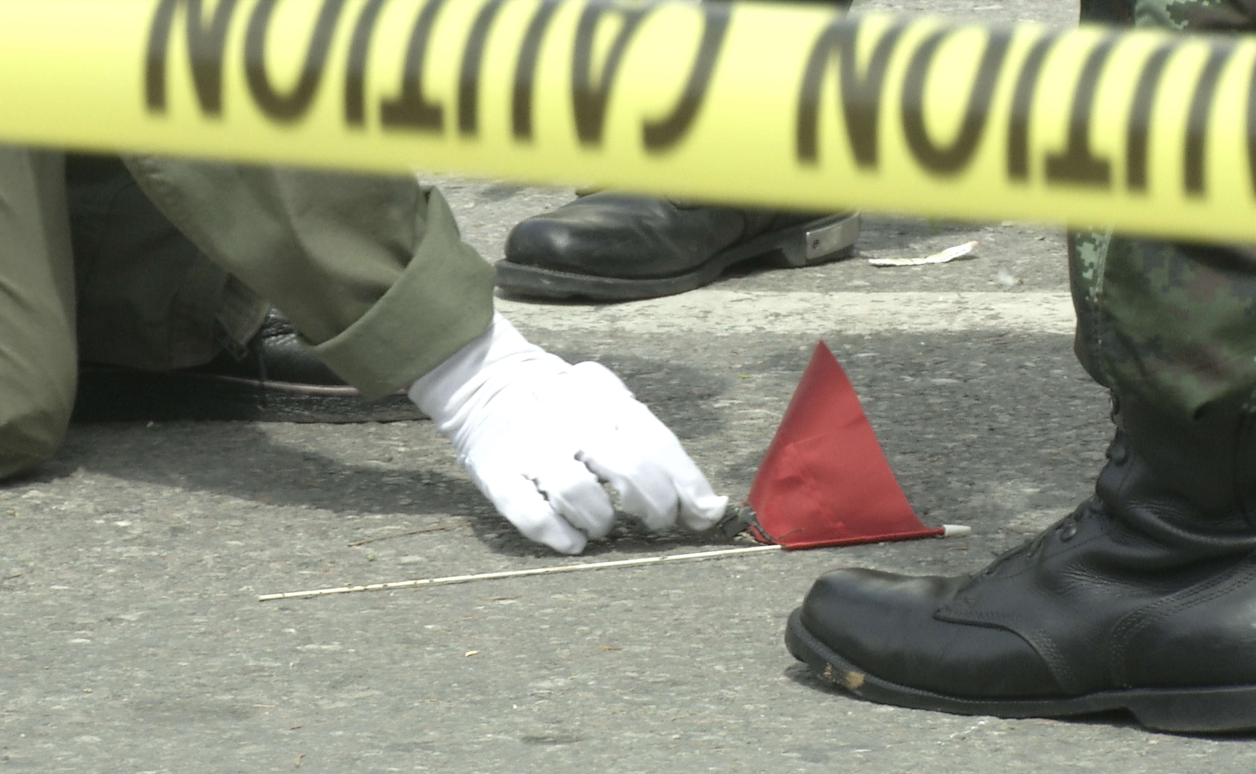 Thai police crime scene investigators search near the clock...