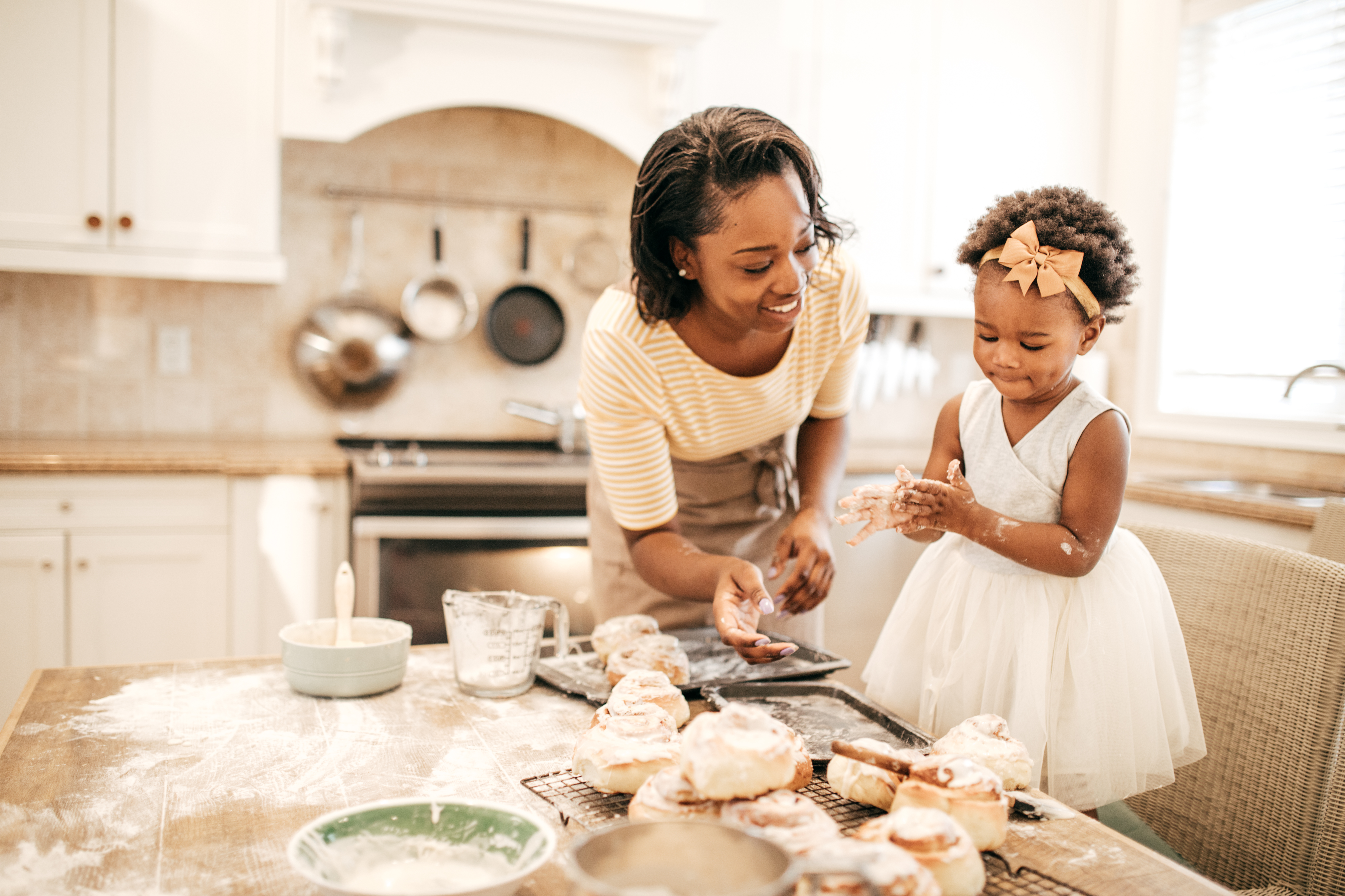 Mom and toddler baking together