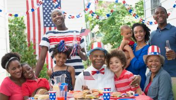 Multi-generation family smiling at Fourth of July barbecue
