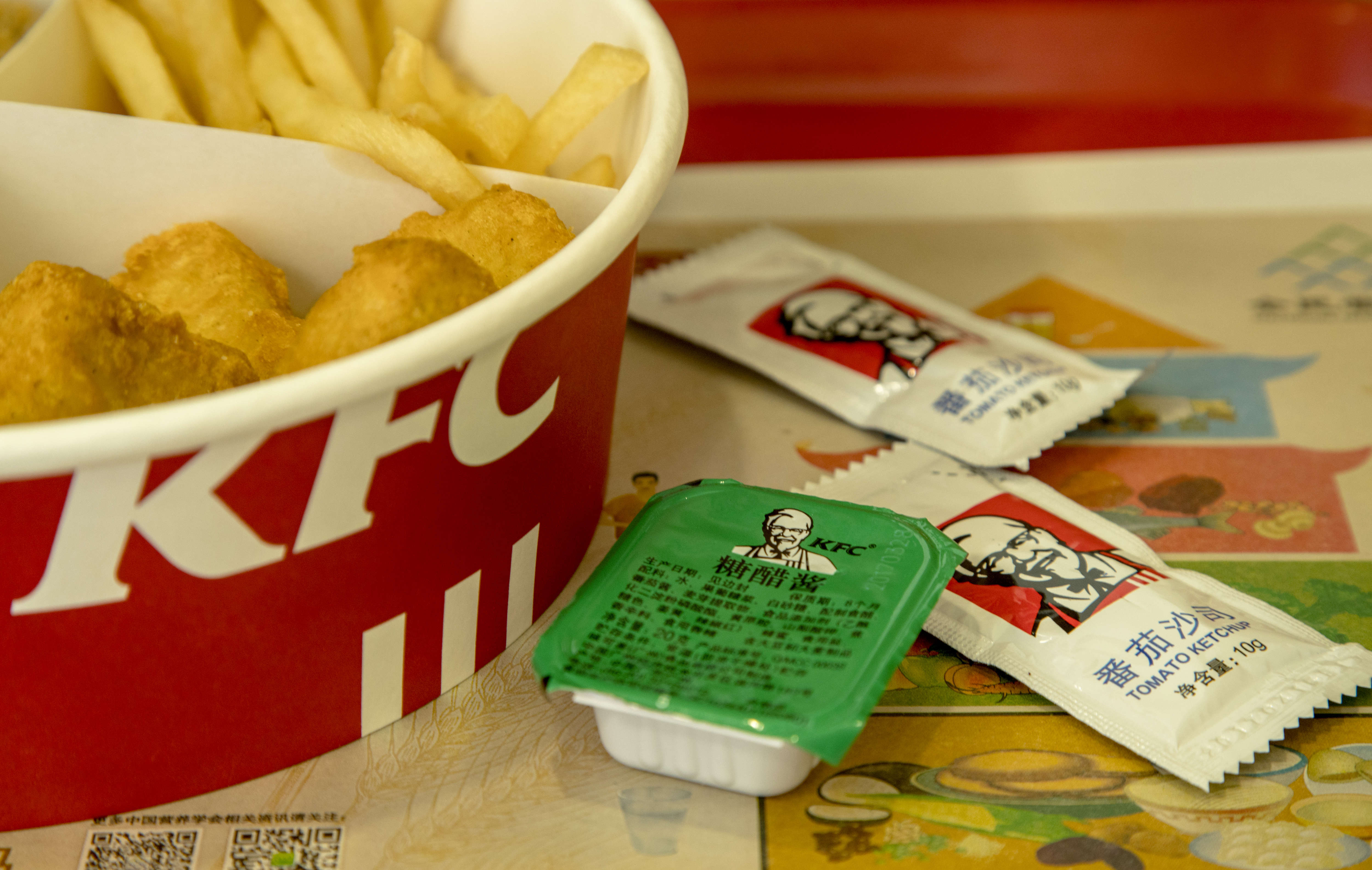 KFC food box filled with fried chicken and chips. Since...