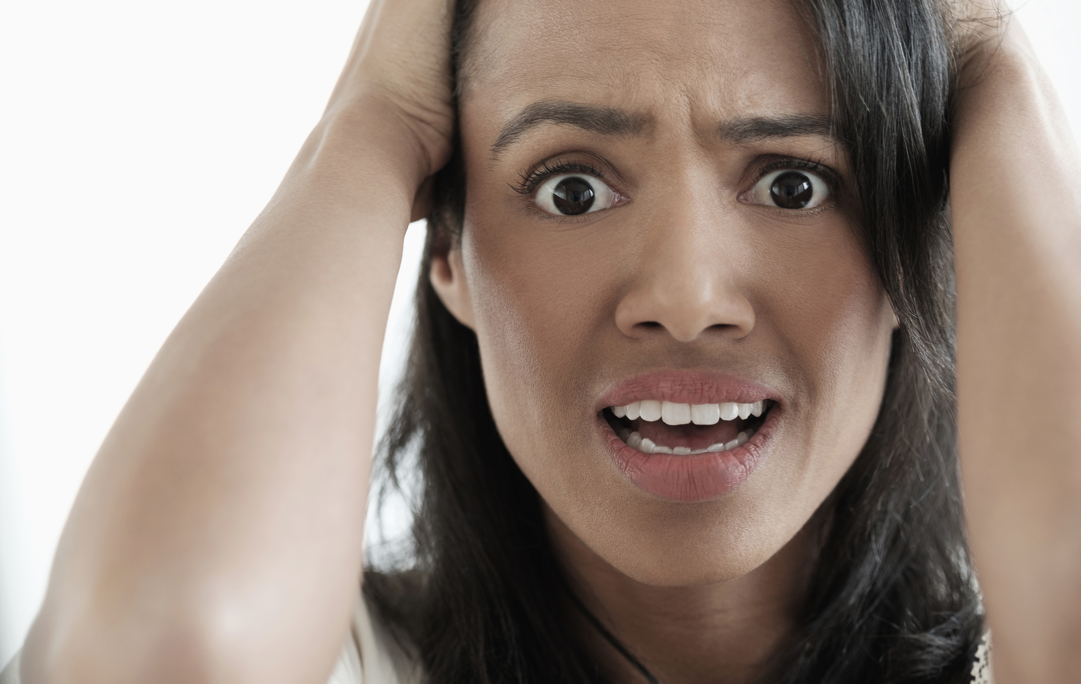 Close up of mixed race woman gasping