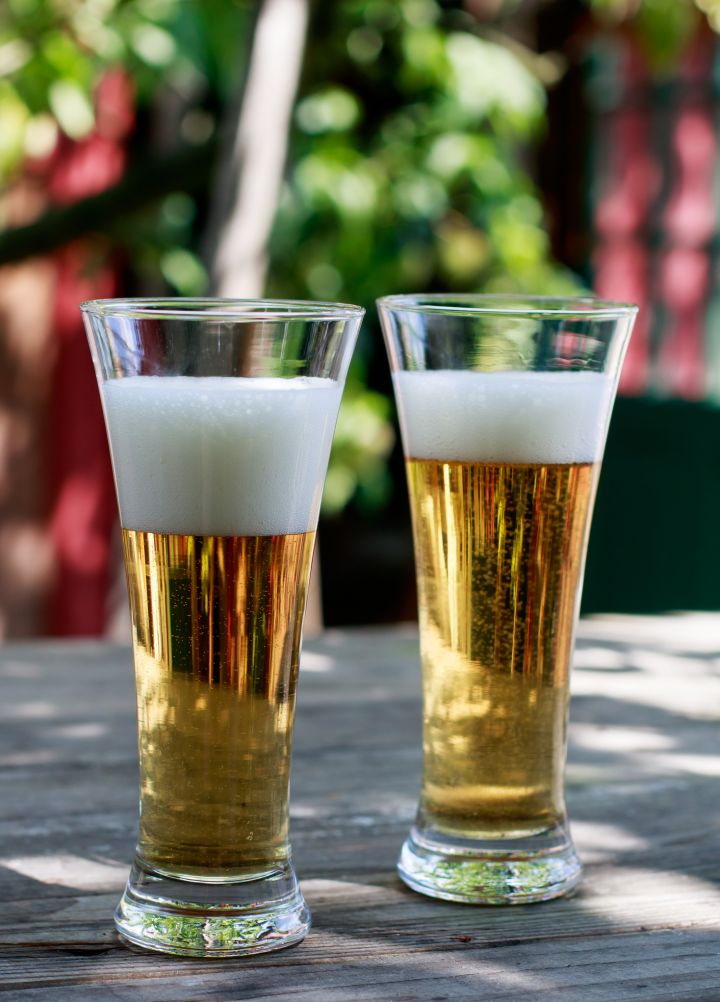 Two glasses of beer on a table in the garden