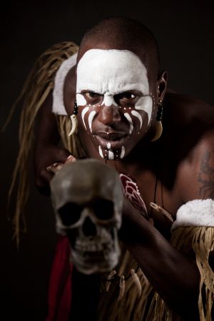 African witch doctor with bodypaint in dramatic light