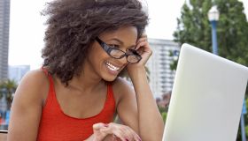Young woman smiling working on a laptop computer