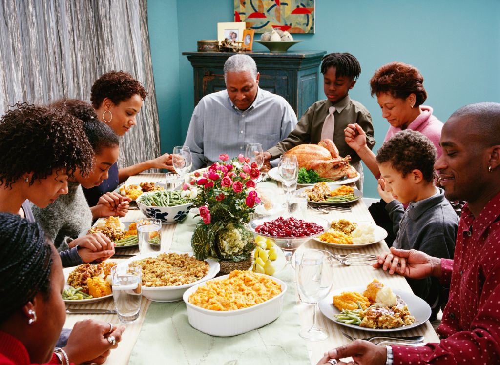 Family Saying Grace at Thanksgiving Dinner