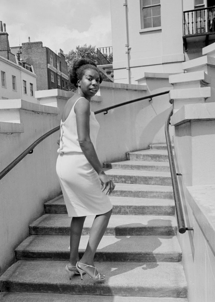 Singer Nina Simone stands on the steps of Philips record company building at Stanhope Place July 1965