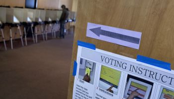 A voter casts his ballot at a voting mac