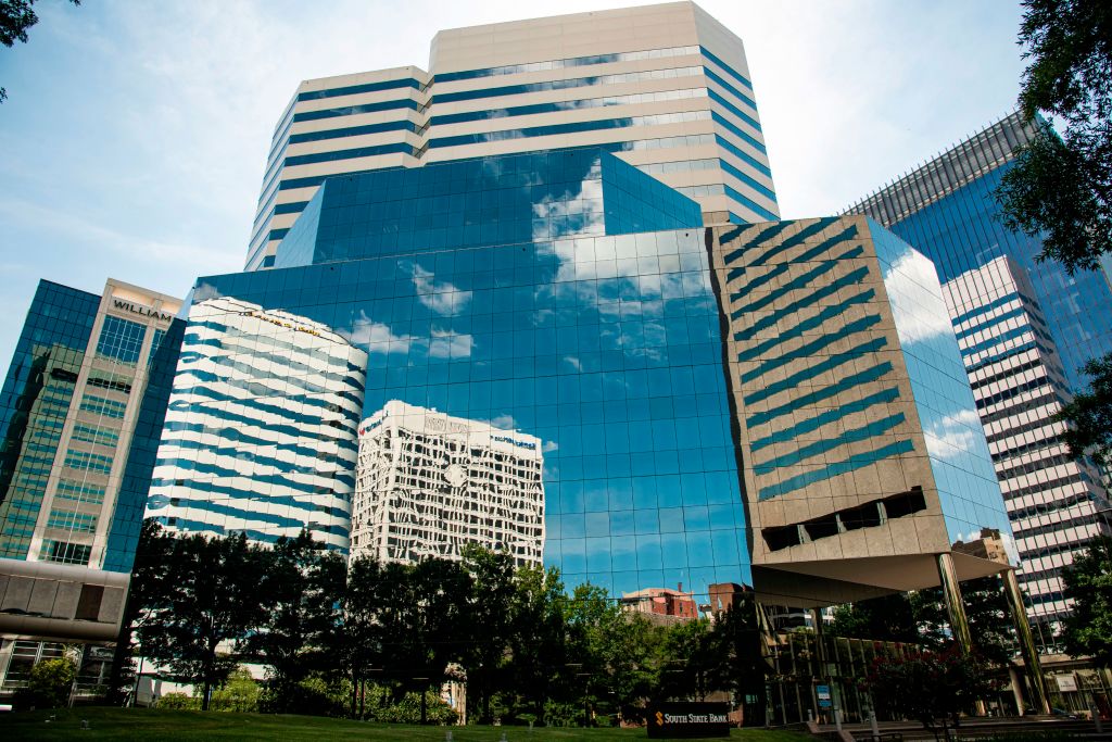 Skyline of Richmond, Virginia reflected on glass front wall of high rise building
