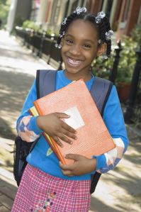 African girl holding school books