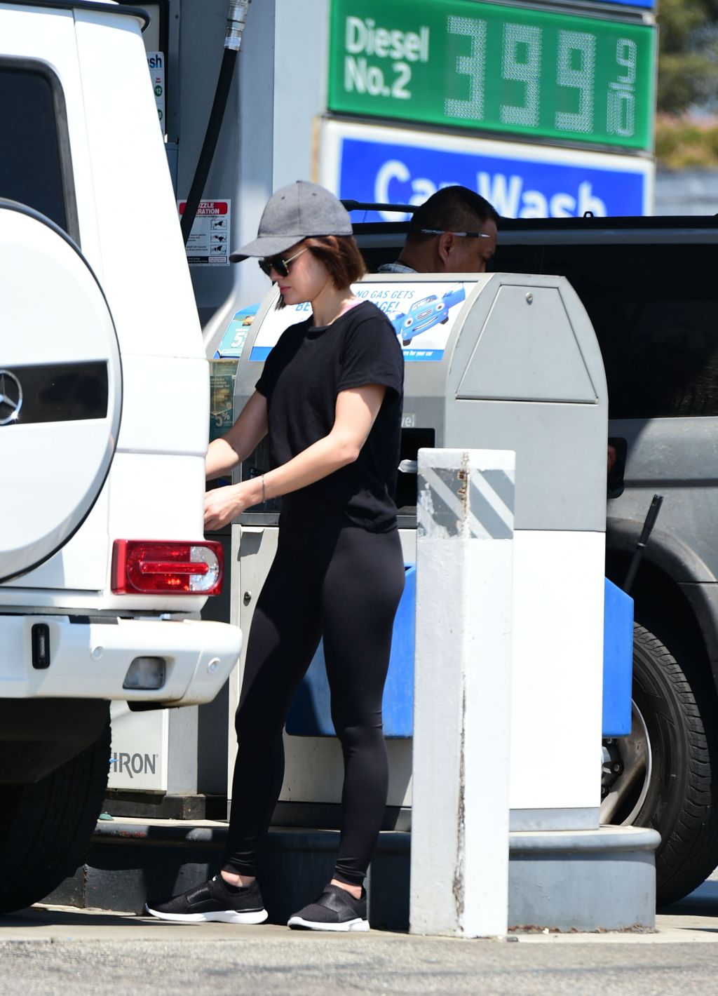 Lucy Hale fills up with gas