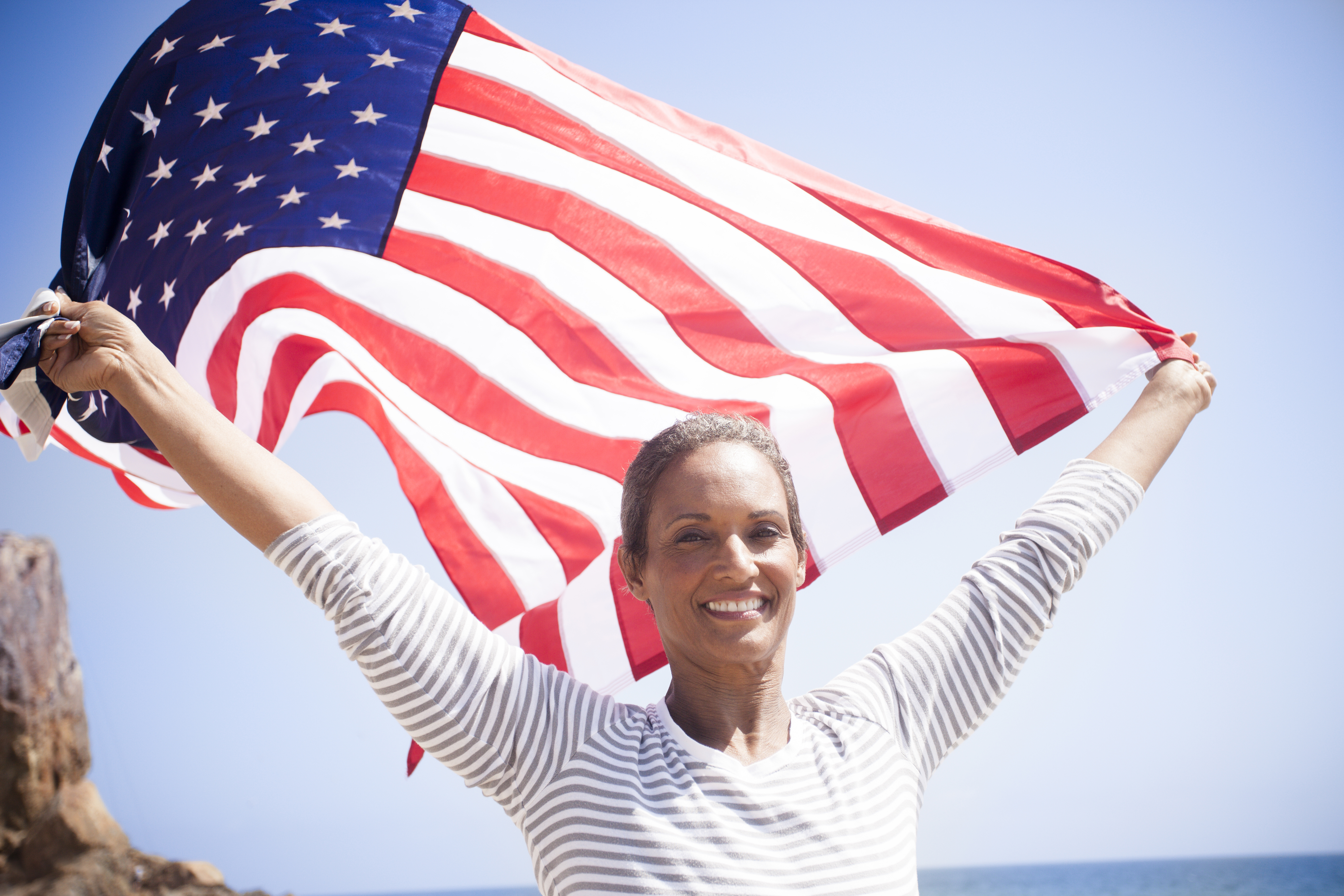African American Senior Carrying USA Flag